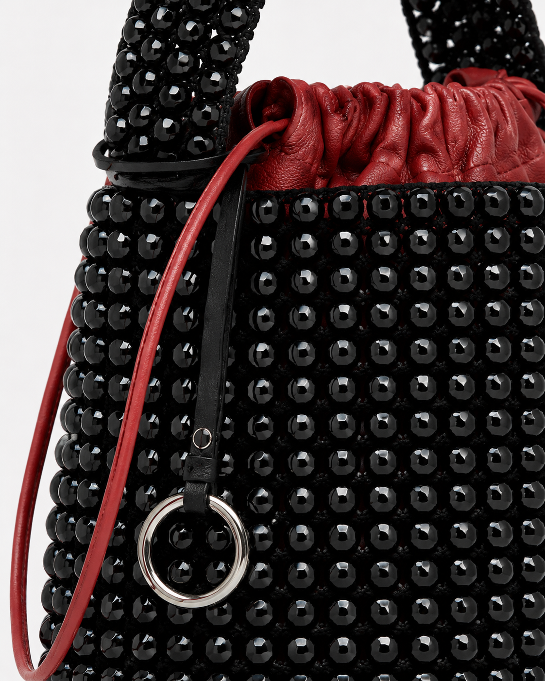 Avant-Garde Beaded Bucket Bag with Contrast Red Leather Drawstring Pouch