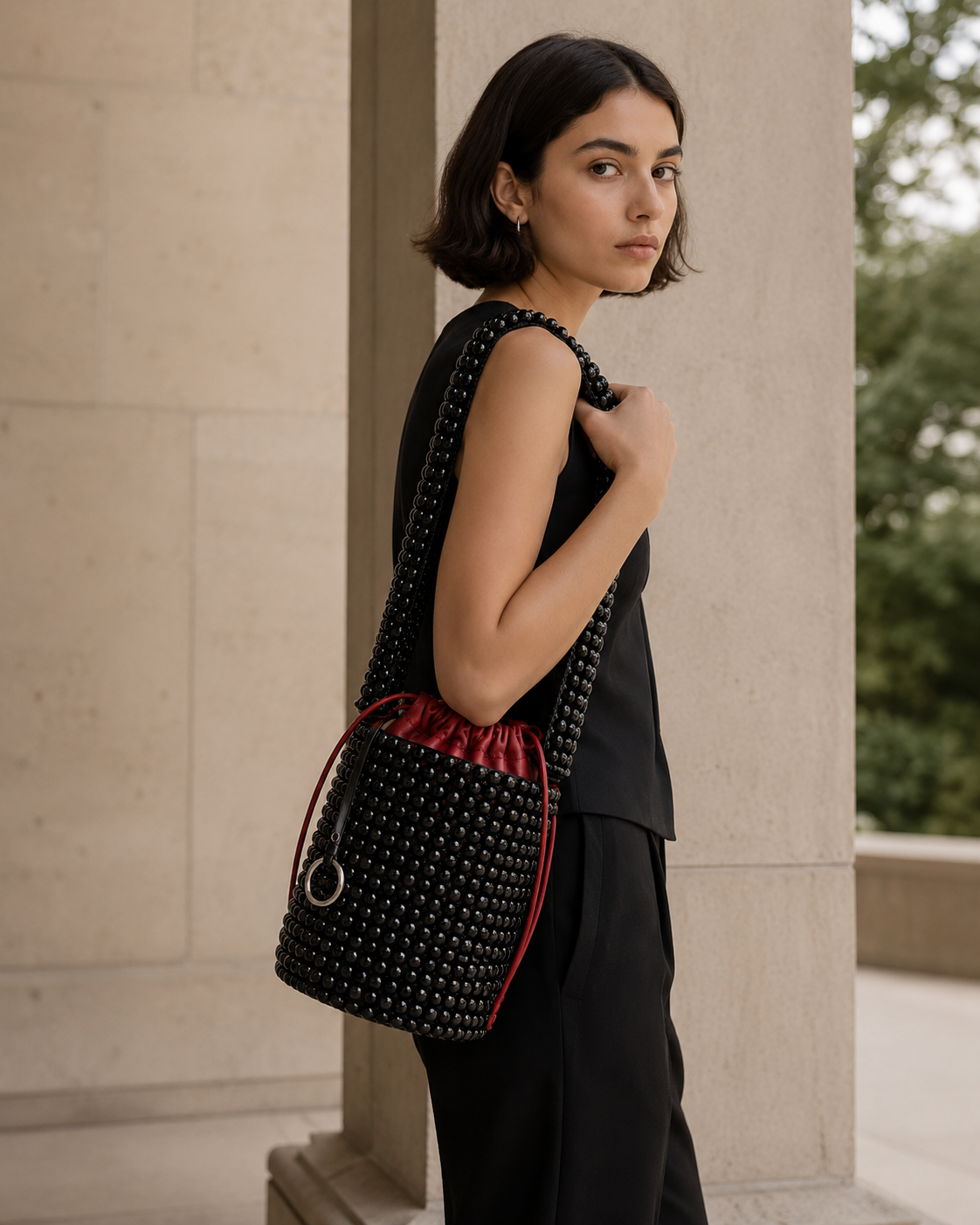 Avant-Garde Beaded Bucket Bag with Contrast Red Leather Drawstring Pouch