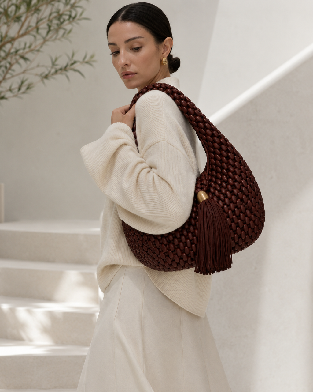 Luxury Woven Leather Hobo Bag with Statement Tassel and Gold Accent