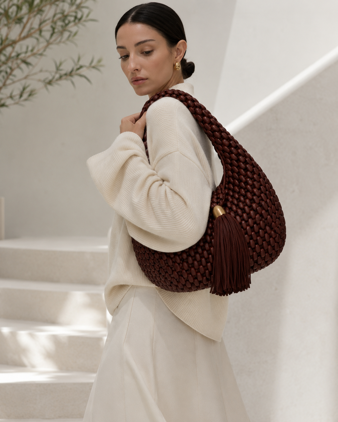 Luxury Woven Leather Hobo Bag with Statement Tassel and Gold Accent